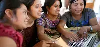young women in Guatemala use a computer. Photo: UN Trust Fund/Phil Borges