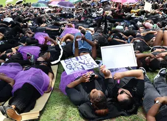 Protesters observe 15 minutes of silence at the Union Buildings in Pretoria on 21 November 2024, lying on the ground to honour the 15 women killed daily in South Africa. Photo: UN Women/Maphuti Mahlaba
