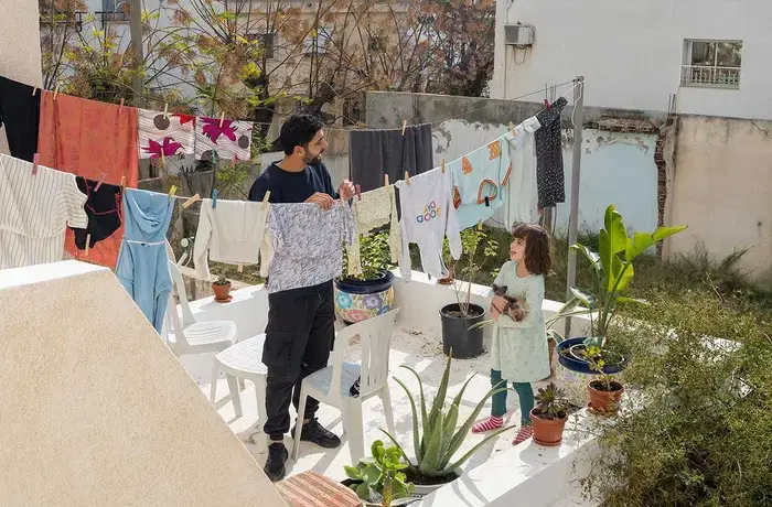 A father and daughter hand out laundry together