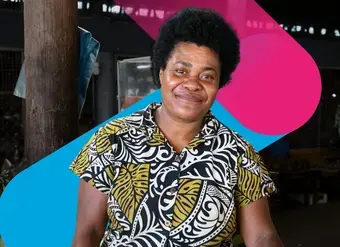 A portrait of a woman fruit vendor at a market in Fiji